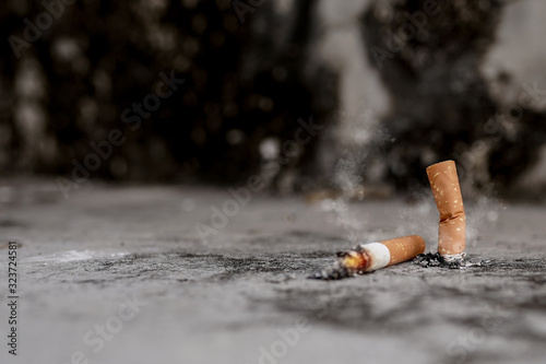 Cigarette butt isolated on the cement floor background