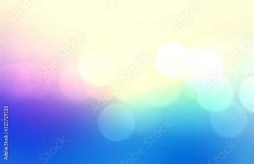 Bright bokeh abstract pattern. Colorful glare blurred texture. Blue lilac yellow vivid gradient background. 