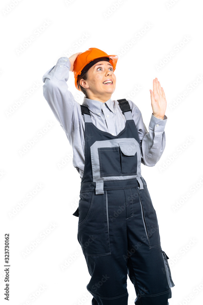 The girl the builder looks from above and is afraid of something. isolated The girl the builder looks from above and is afraid of something. isolated
