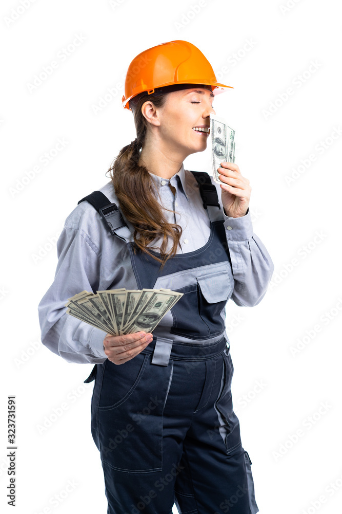 construction worker girl. The girl earned a lot of money. She sniffs dollars for happiness. Isolated construction worker girl. The girl earned a lot of money. She sniffs dollars for happiness. Isolated