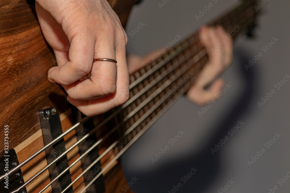 Playing the guitar, fingers the strings of the guitar.