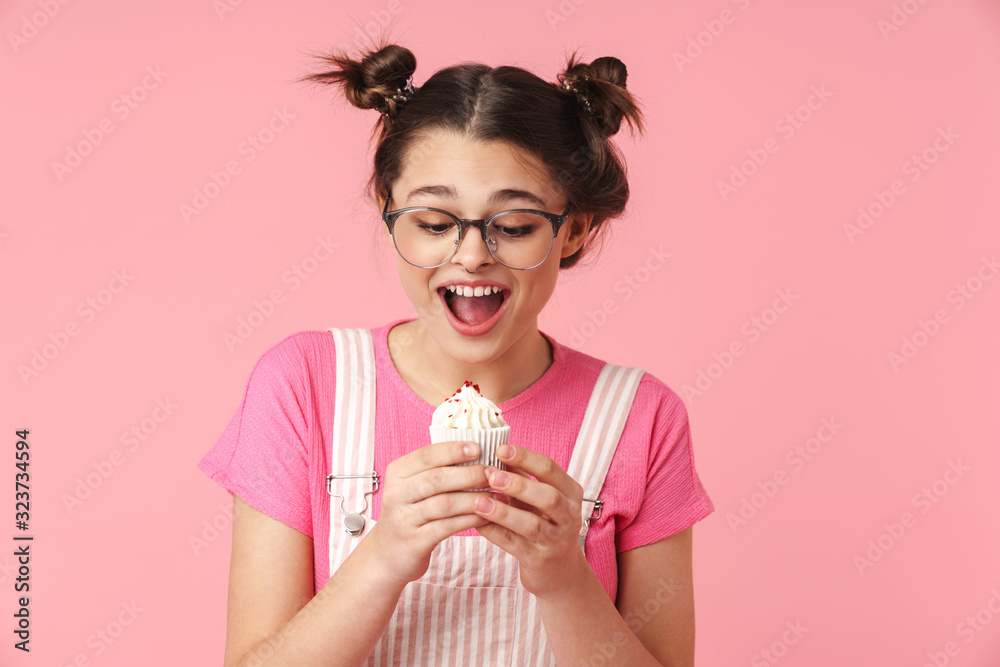 Photo of excited charming girl holding cake and expressing surprise Photo of excited charming girl holding cake and expressing surprise