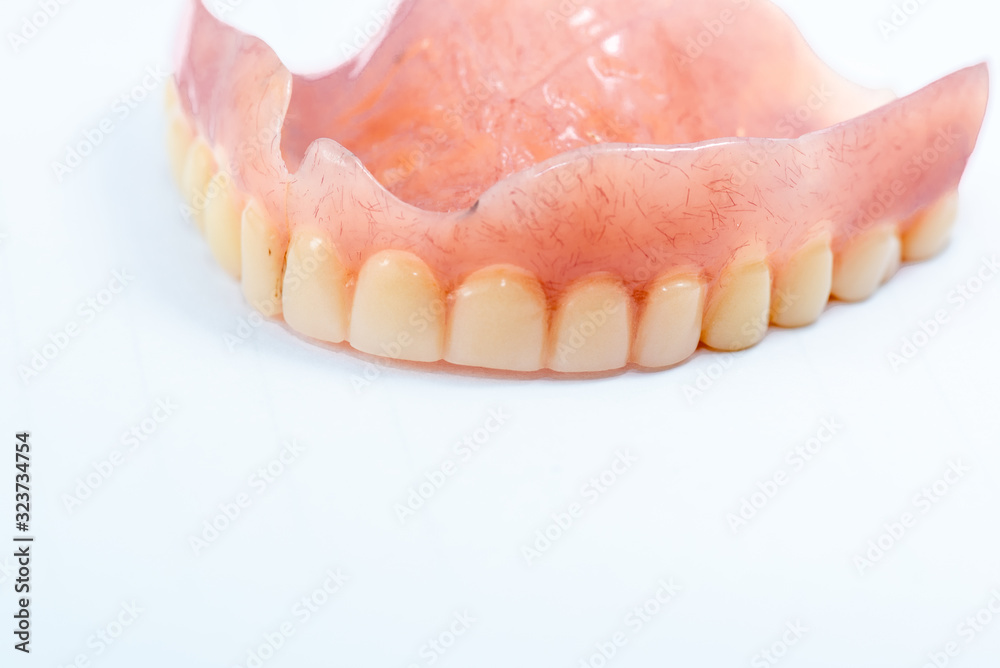 Old denture on a white background. Old denture on a white background.