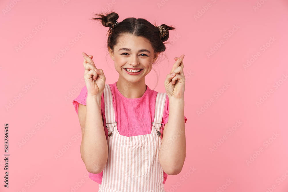 Photo of funny girl holding fingers crossed for good luck and smiling Photo of funny girl holding fingers crossed for good luck and smiling