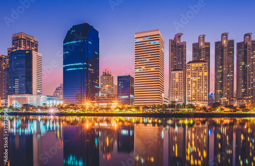Business district cityscape from park,Benchakitti Park in Morning with cityscape reflection, Bangkok Thailand.