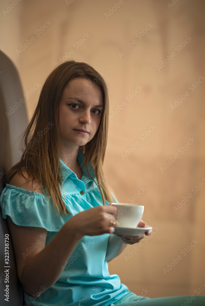 Beautiful girl is drinking coffee in a cafe. Beautiful girl is drinking coffee in a cafe.