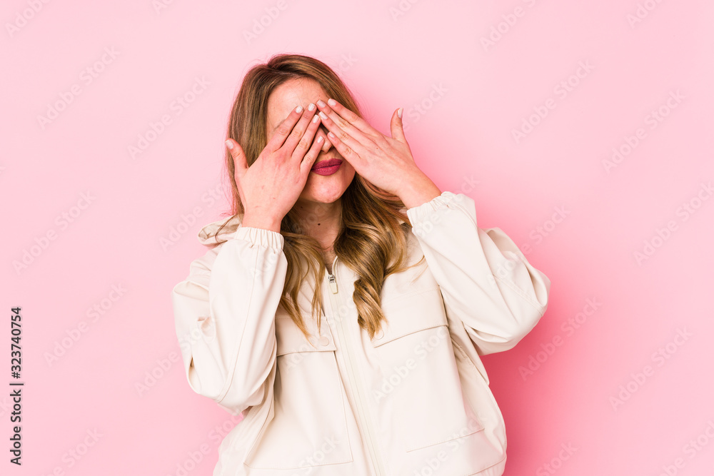 Young caucasian woman isolated on pink background afraid covering eyes with hands. Young caucasian woman isolated on pink background afraid covering eyes with hands.