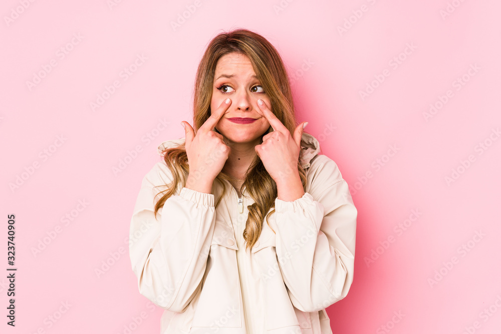 Young caucasian woman isolated on pink background crying, unhappy with something, agony and confusion concept. Young caucasian woman isolated on pink background crying, unhappy with something, agony and confusion concept.