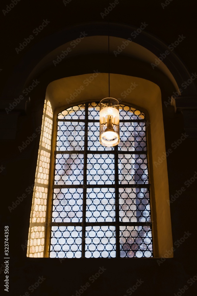 Beautiful window and a lamp in the german catholic church