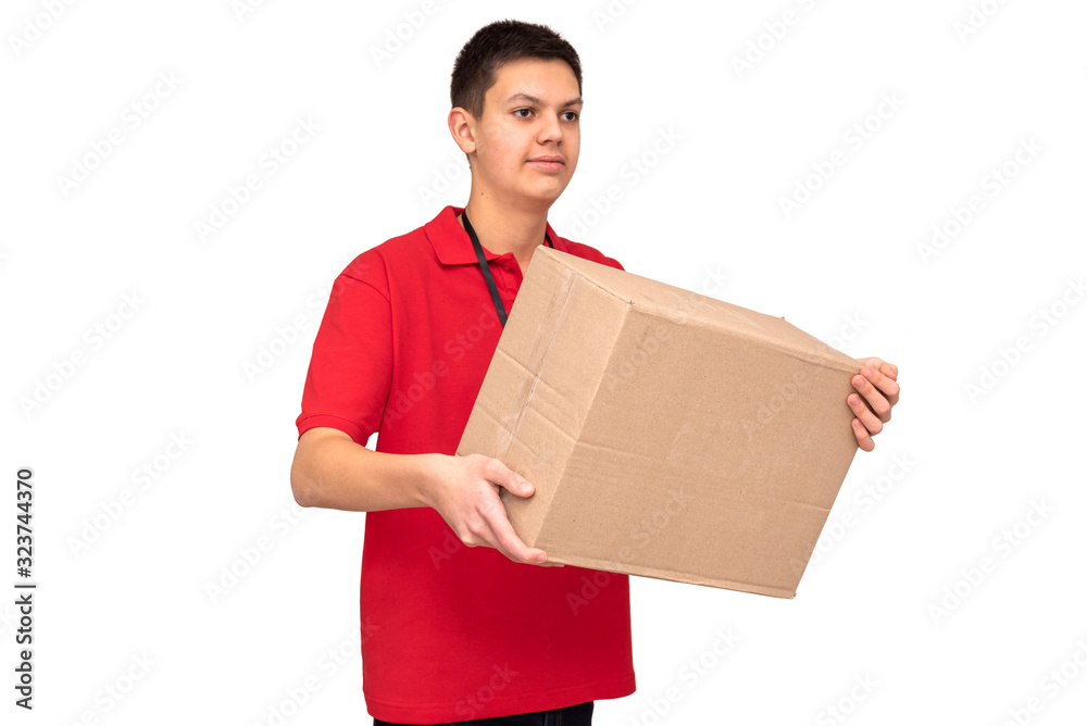 Young friendly delivery courier dressed in red T-shirt with name tag holding cardboard box with order isolated on white background. Close-up. Delivery service and logistic concept Young friendly delivery courier dressed in red T-shirt with name tag holding cardboard box with order isolated on white background. Close-up. Delivery service and logistic concept