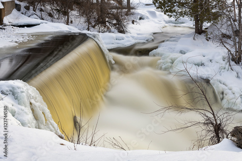 Buttermilk Falls in Forest Mills Ontario Canada.  A large cascade waterfall that thunders through the river in winter.  