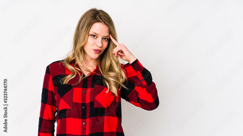 Young cauciasian woman isolated on white background pointing temple with finger, thinking, focused on a task. Young cauciasian woman isolated on white background pointing temple with finger, thinking, focused on a task.