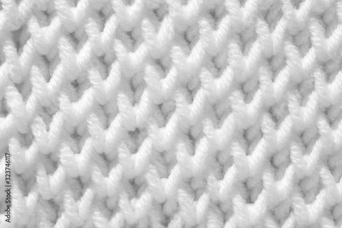 Handmade knitting texture, white background. Gray wool with fine threads, close-up. © Nadzeya Pakhomava