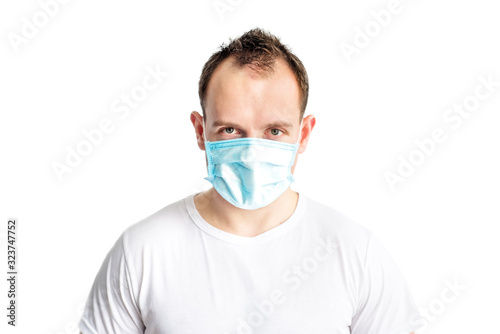 Portrait of serious and self confident caucasian man in blue medical mask on face. Health care in cold season. Prevention of coronavirus covid-2019. Stop coronavirus. Medical and health care.