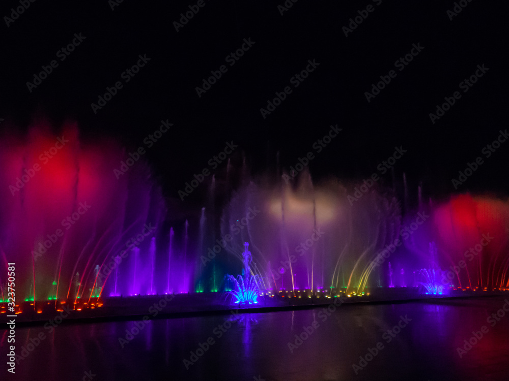 Fototapeta Nha Trang, Vietnam - December 23, 2019: View of the Fountain Show in the Vinpearl Amusement Park by night.