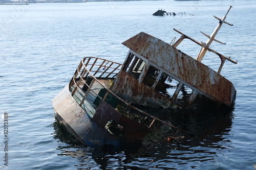 sunken boat near the rocks