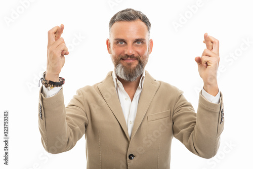 Portrait of handsome man wearing smart casual holding fingers crossed