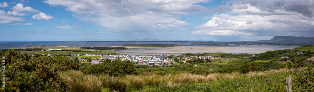 Panorama view of an irish village close to the beach during a blue sunny day 
