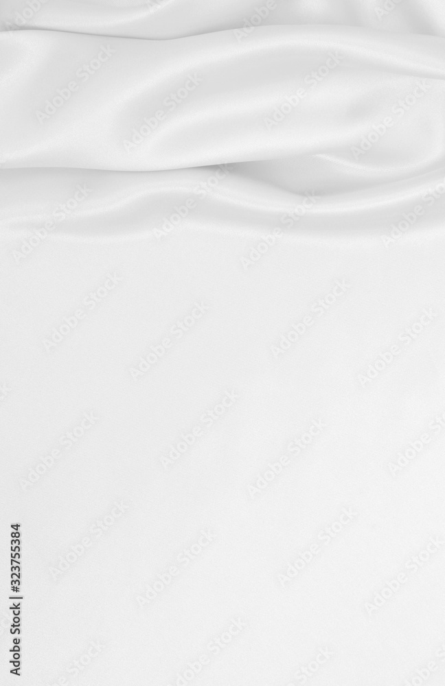 Smooth elegant white silk or satin luxury cloth texture as wedding background. Luxurious background design