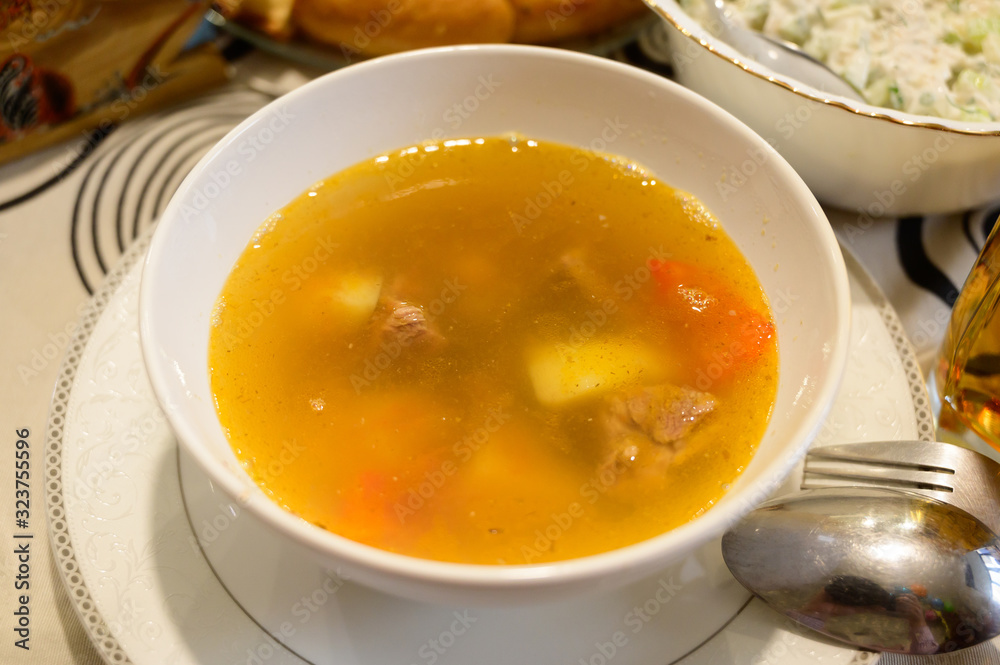 Meat soup in plate on a table Meat soup in plate on a table