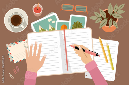 Woman s hands holding pen and writing in diary. Personal planning and organization. Workplace