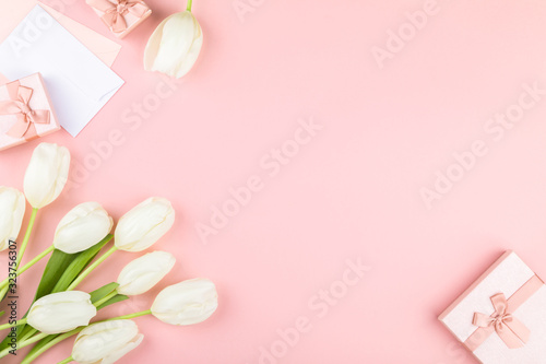 White tulip on pastel pink background. Traditional holiday gift. © lily_rocha
