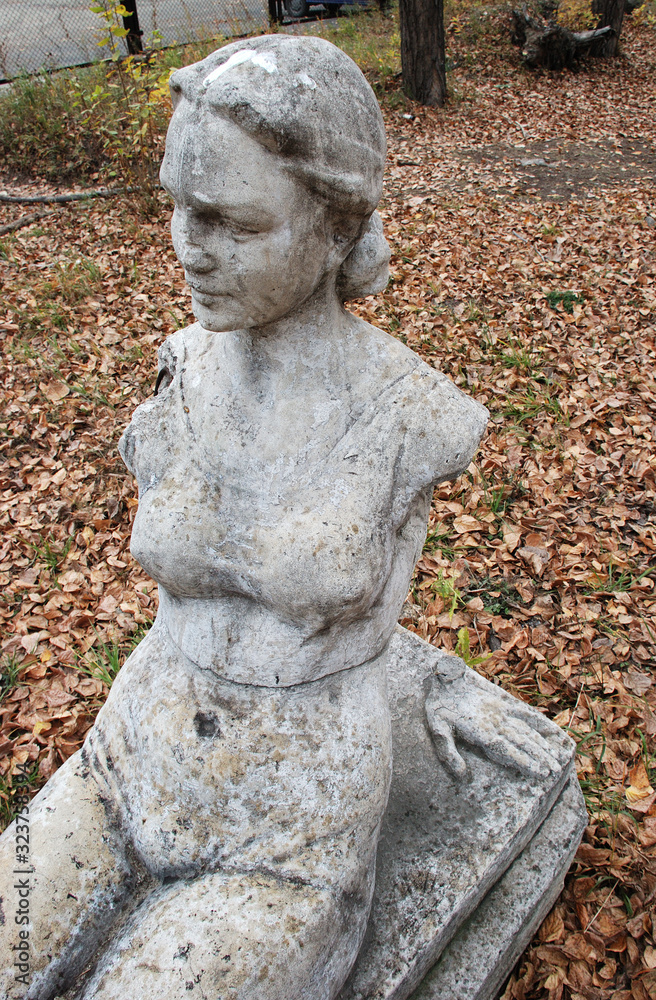 Old statue of a woman with broken hands.