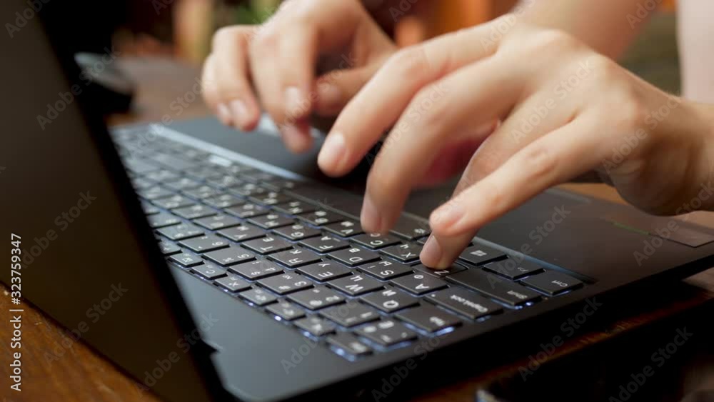 Female Company Worker Inputs Data On Keyboard Of Black Laptop. E-business Concept Female Company Worker Inputs Data On Keyboard Of Black Laptop. E-business Concept