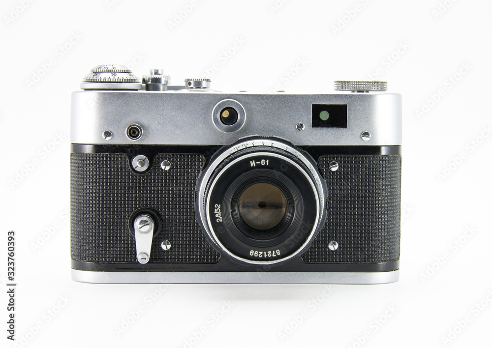 Old film retro camera with lens. Metallic black. White isolated background. Front view