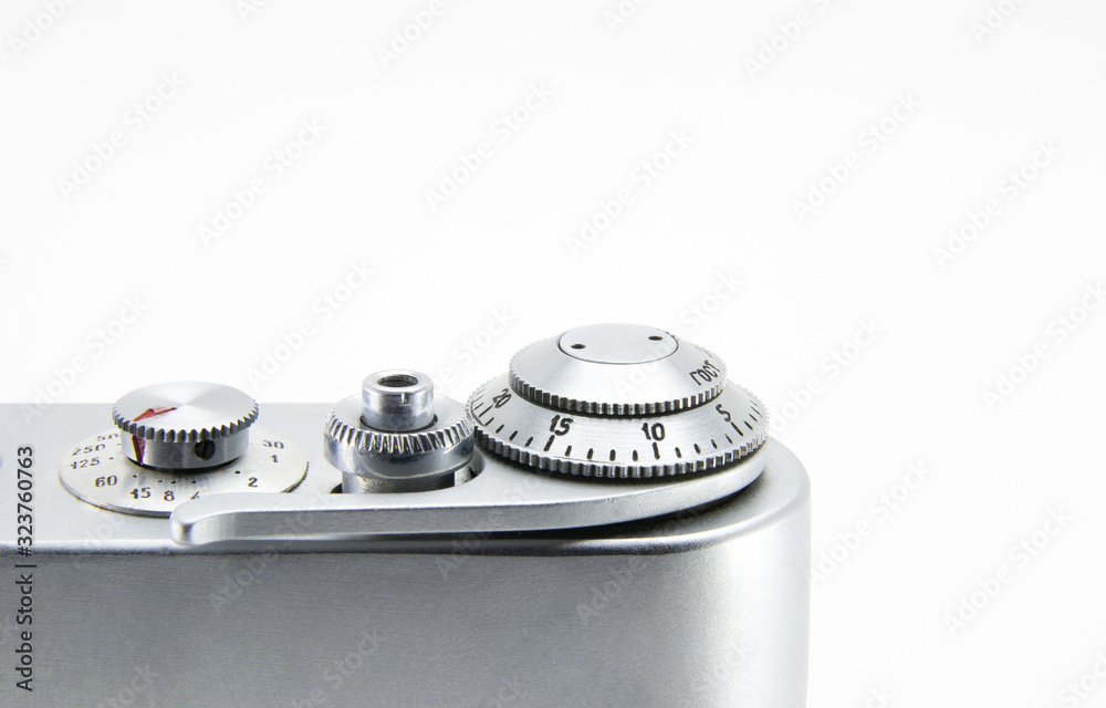 Old film retro camera. Shutter and trigger (button) close-up. Metallic black. White isolated background. Old film retro camera. Shutter and trigger (button) close-up. Metallic black. White isolated background.