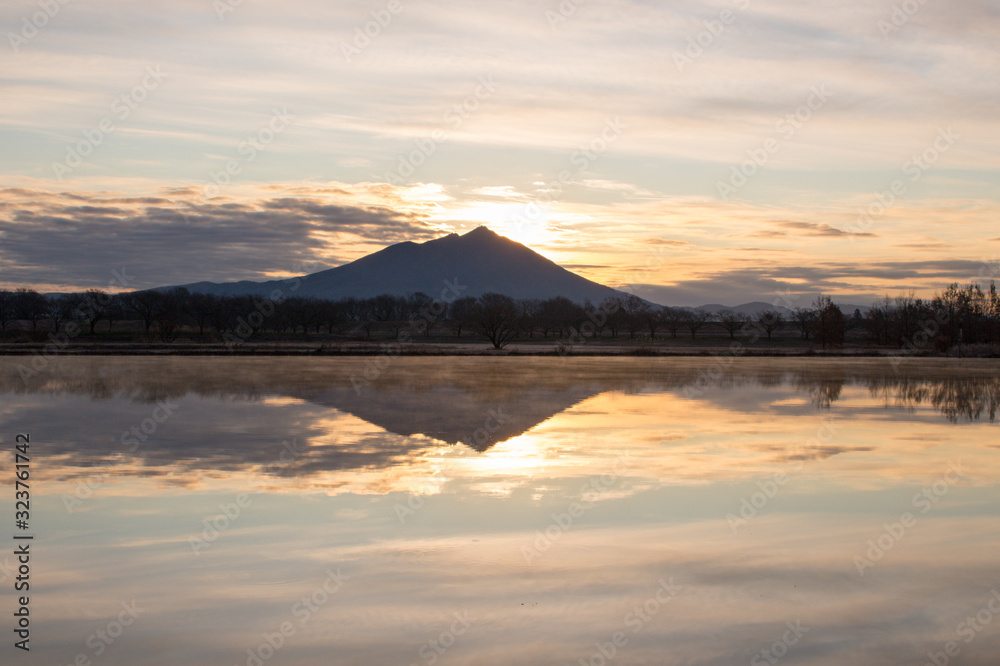 Mount Tsukuba and the morning glow sky and their reflection on the lake surface