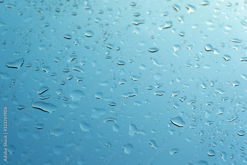 Water drops on the glass against the blue sky. Water drops on the glass against the blue sky.
