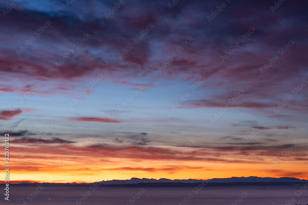 Fototapeta premium sunrise at the lake on a pier with panorama view to the mountains