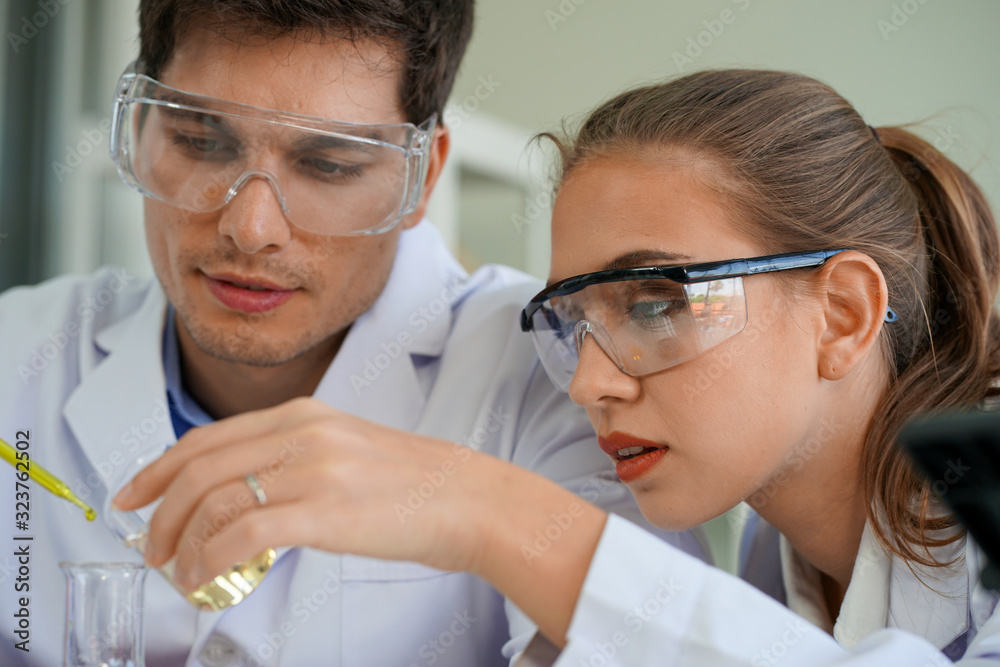 the european young medical scientists analysing the test tube of Virus in Laboratory for disease outbreak prevention and cure in clinical hospital the european young medical scientists analysing the test tube of Virus in Laboratory for disease outbreak prevention and cure in clinical hospital
