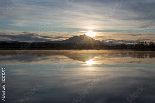 The sun rising to the top of Mt.Tsukuba and its reflection on the lake surface