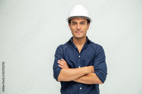 Handsome man industrial engineer wearing a white helmet solated on white background
