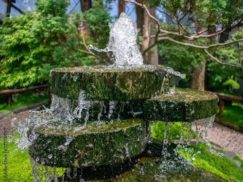 green nature and artificial water cascade