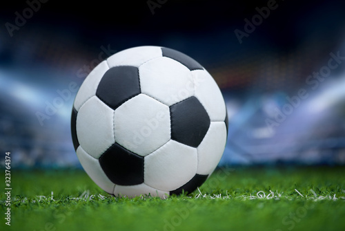 Closeup soccer ball in green grass on stadium