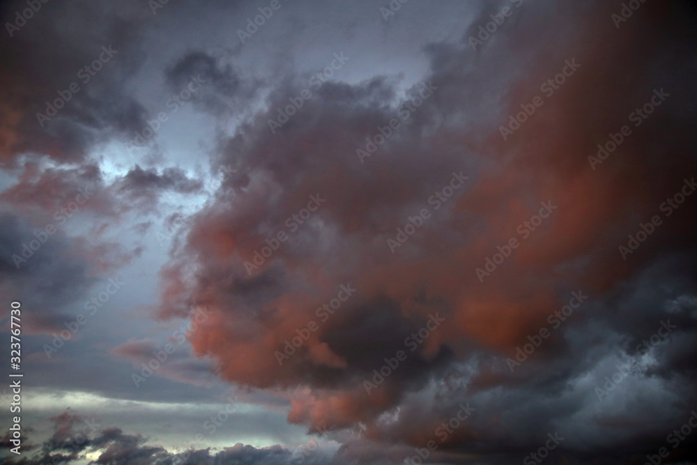 Beautiful evening sky with multi-colored bright clouds. Rain clouds at sunset