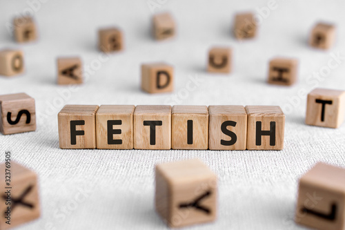 Fetish - words from wooden blocks with letters, worshiped object fetish concept, white background