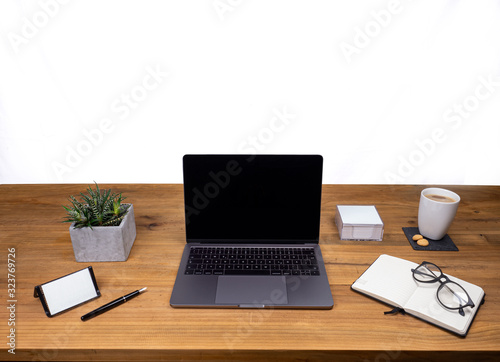 Table shot desk view with pencil a plant, coffee, workspace, business, laptop display and notes business card