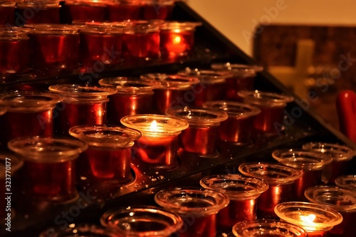 Burning Candles with selective focus on blurred background. Candles with soft focus in the cathedral. sacrificial or memorial candles lit in a church.