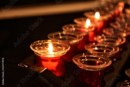 Burning Candles with selective focus on blurred background. Candles with soft focus in the cathedral. sacrificial or memorial candles lit in a church.