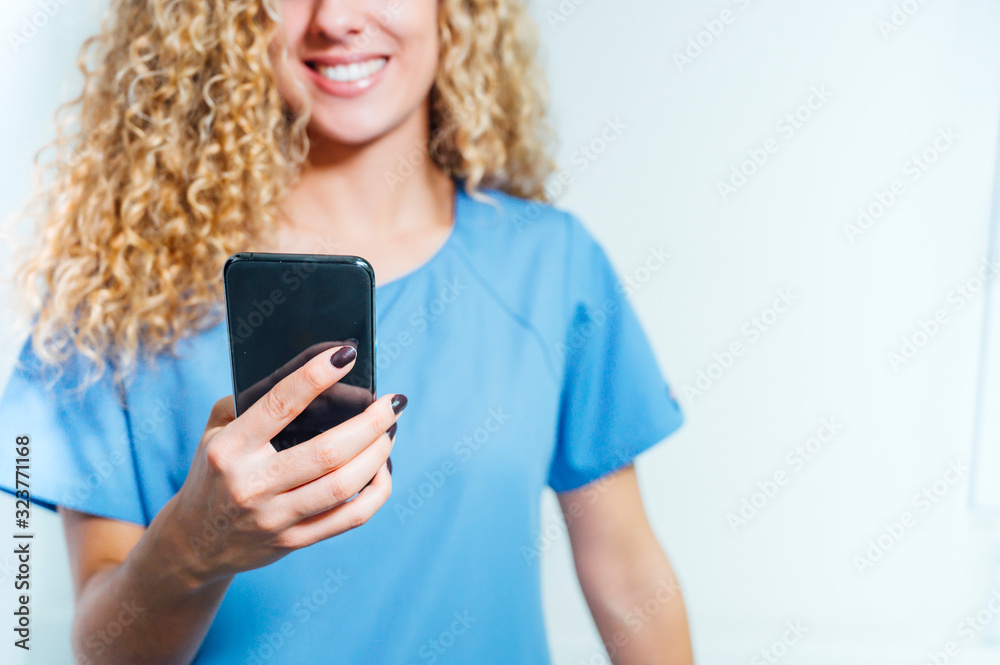 Closeup of nurse holding a mobile phone