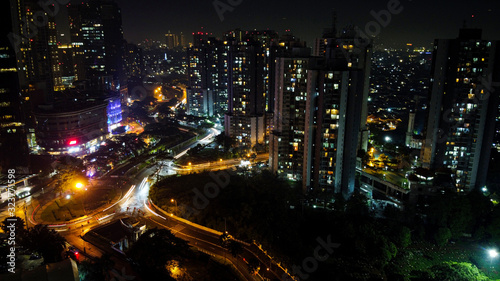 Modern buildings of Jakarta with lights at night on background, view from Kuningan Jakarta, Indonesia © syahrir