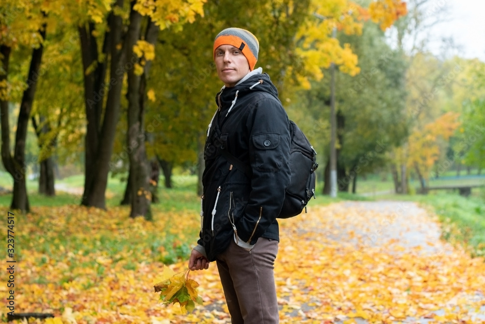 Man in the Indian summer. With leaves of trees. Man in the Indian summer. With leaves of trees.