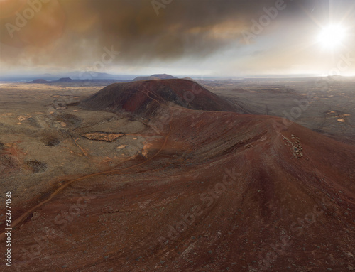 Volcano mountain sunrise with red rock and sunrise aerial shot