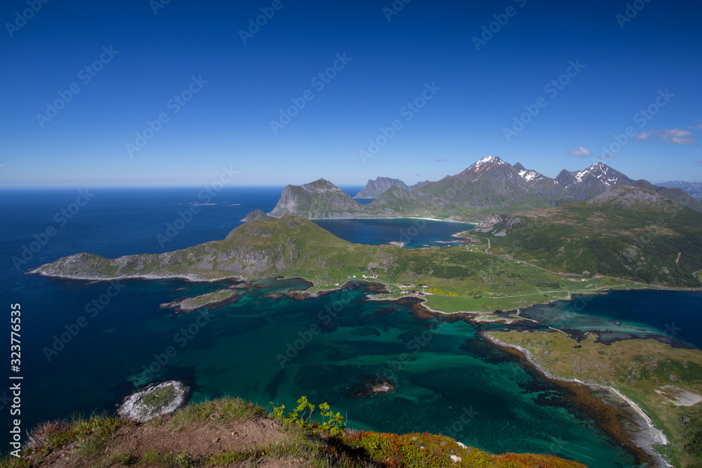 Mountains rise strait out of the sea. Offersoy Lofoten Norway. Mountains rise strait out of the sea. Offersoy Lofoten Norway.