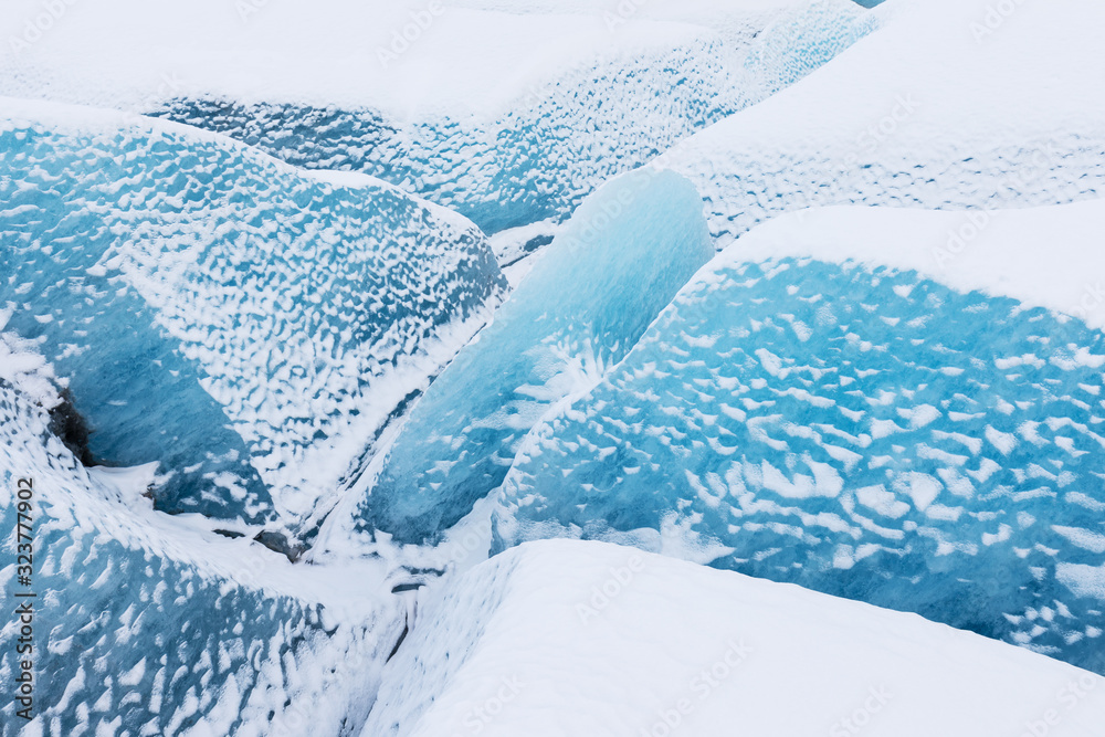 Fototapeta premium Mountains with clouds on Antarctica. Glaciers, icebergs and ice caves of Southern hemisphere. Global climate change on Earth. Importance of ecological balance on the planet. Landscape with blue ice.