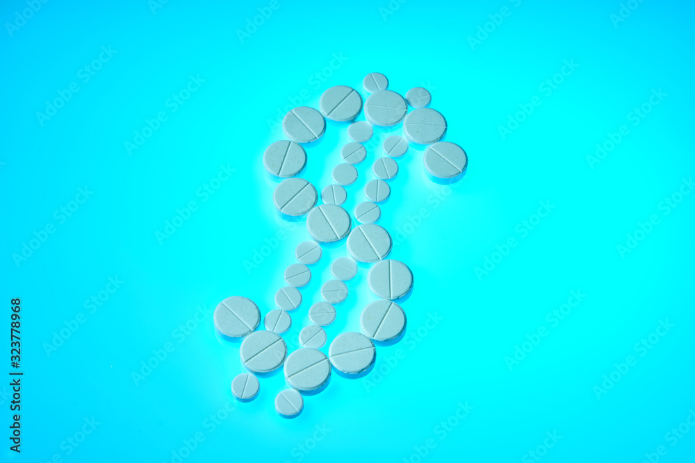 Dollar sign made from white pills on a blue background. Drugs bring money. Pharmaceutical business. Pharmacy business, medicine pill concept. Dollar sign made from white pills on a blue background. Drugs bring money. Pharmaceutical business. Pharmacy business, medicine pill concept.